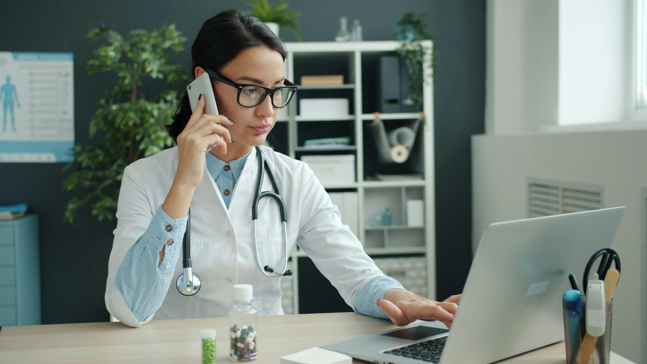 Medical professional coordinating a procurement call from her office